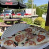 Best pizza in Southern Maine – slice of White Tomato Basil pizza on the outdoor patio at Seacoast Pizza and Pasta