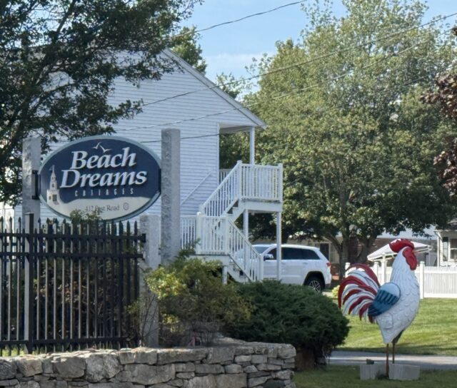 Colorful rooster statue outside Beach Dreams Cottages in Wells, Maine